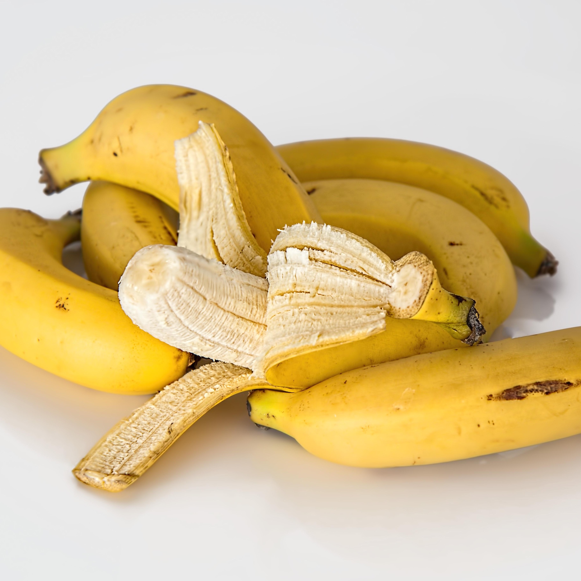 Foto: Bananen, eine davon teilweise geschält